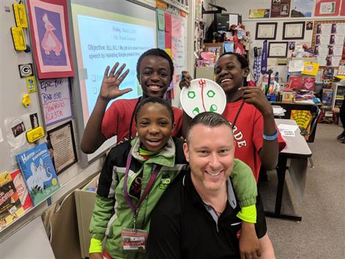 students smile next to thier teacher